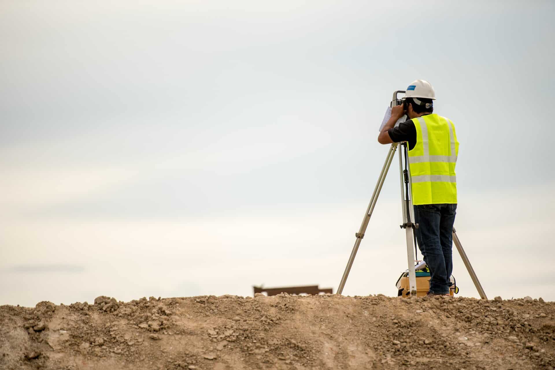 stock-photo-survey-engineer-in-construction-site-use-theodolite-mark-a-concrete-pile-co-ordinate-673722793
